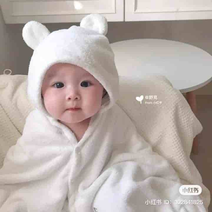 The image of a super cute and charming baby wearing a bear