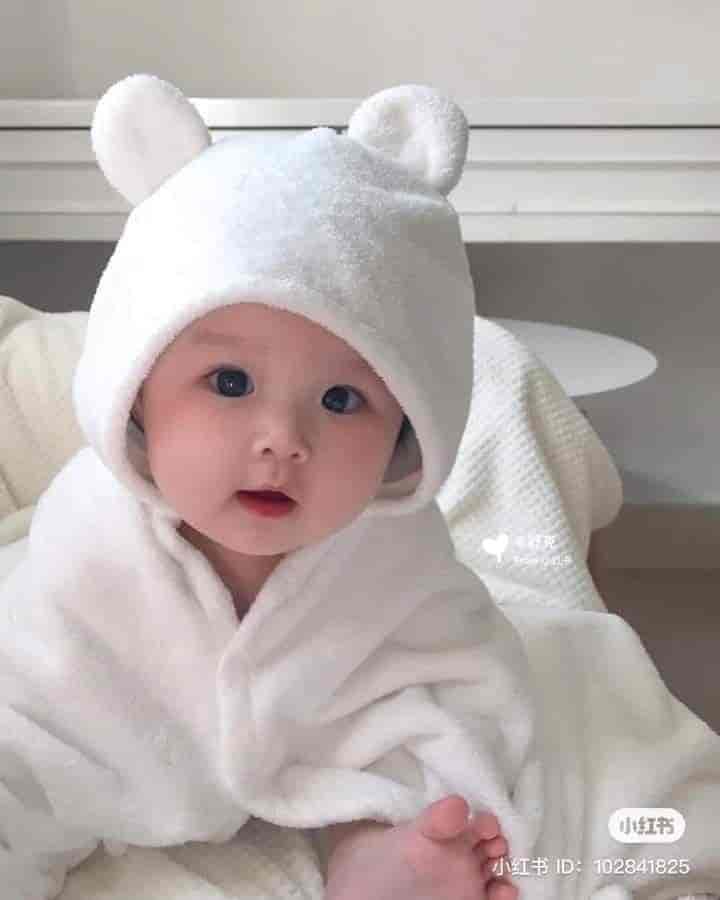 The image of a super cute and charming baby wearing a bear