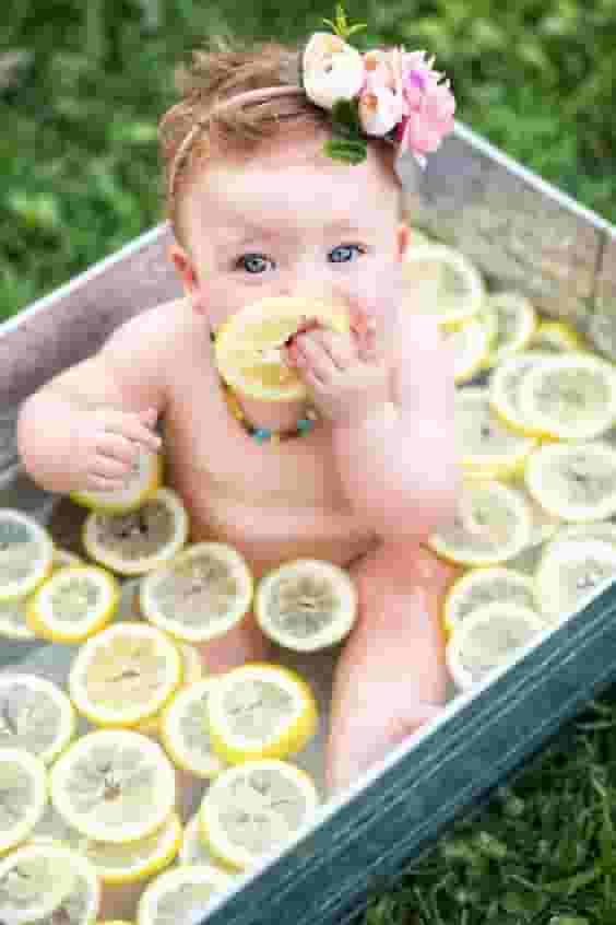 The cuteness of the children is captured through images of them bathing with delicious fruit.