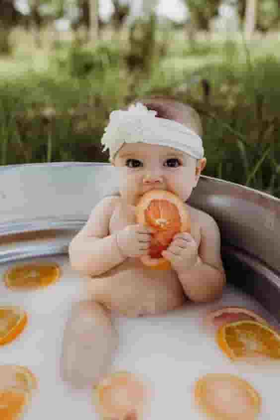 The cuteness of the children is captured through images of them bathing with delicious fruit.