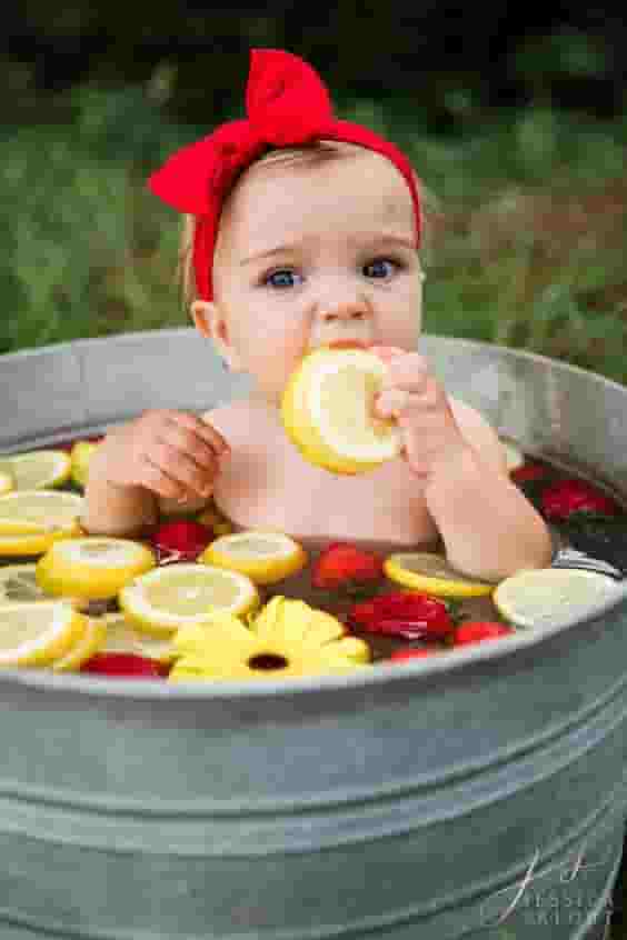 The cuteness of the children is captured through images of them bathing with delicious fruit.