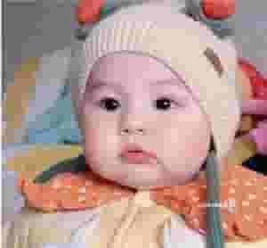 QL Heartwarming Scene: Young girl with rosy cheeks enjoying cake ‎